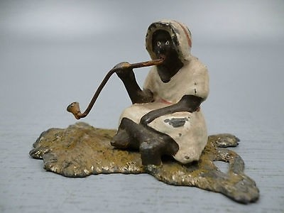 Antique Cold Painted White Metal Figurine of an Arab on Lion Skin Rug 