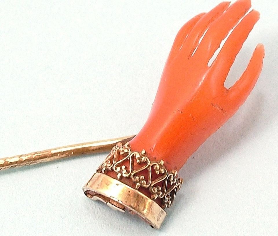   GILT METAL, CORAL BAKELITE, OPEN HAND/ FRIENDSHIP, CRAVAT PIN