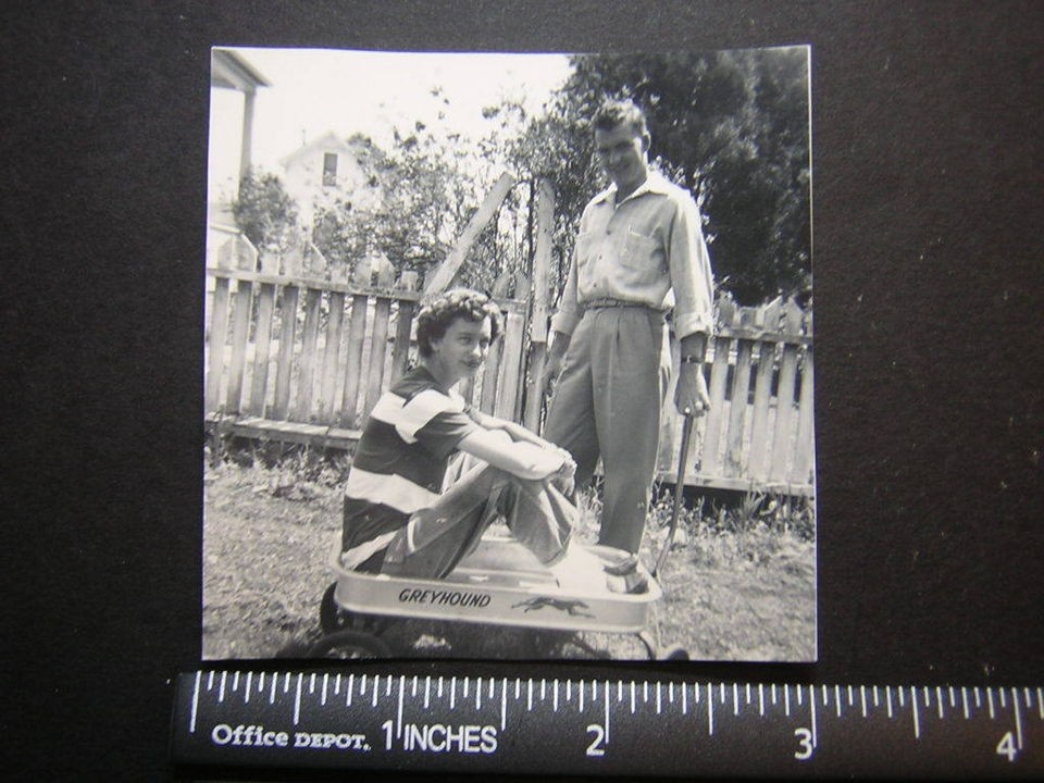 Photo 02879 young lady sits in Greyhound wagon, w man pulling