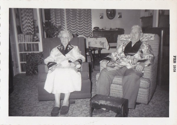   PHOTO ELDERLY MAN & WOMAN IN CHAIRS SMOKING JACKETS TELEPHONE 1958