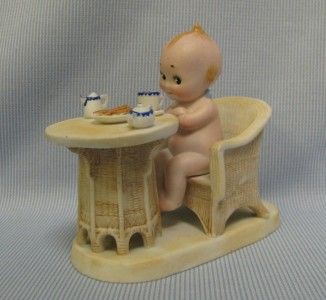 1913 Rose ONeill Kewpie on platform with Wicker Chair & Table Having 